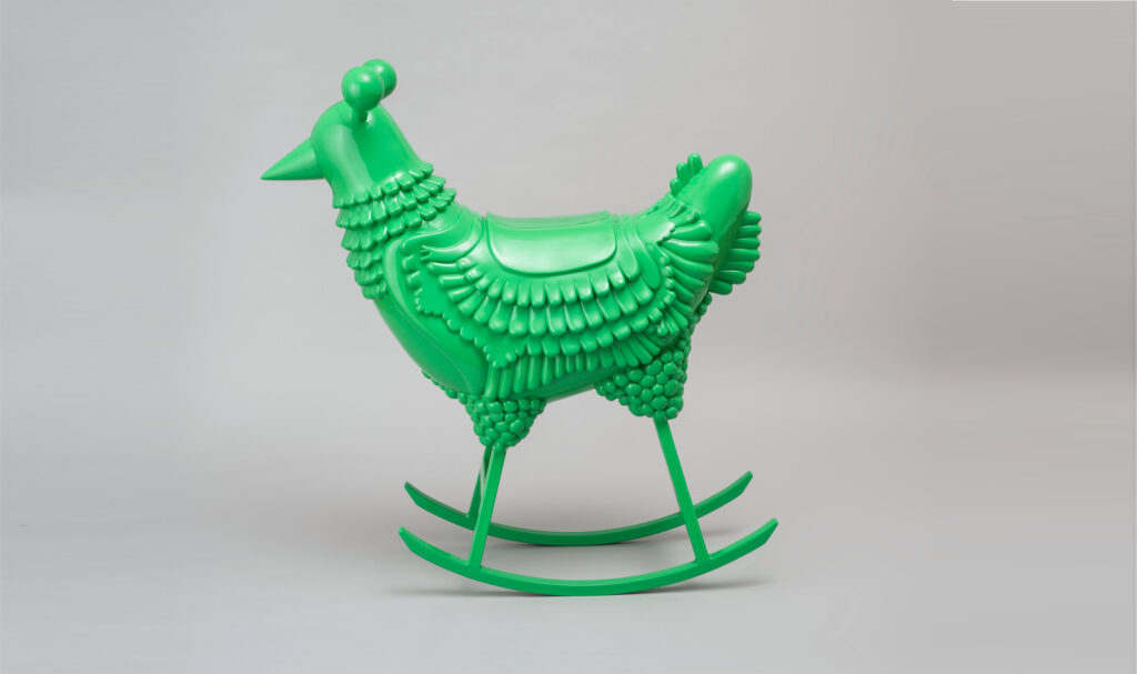 Shiny green chicken on rockers.