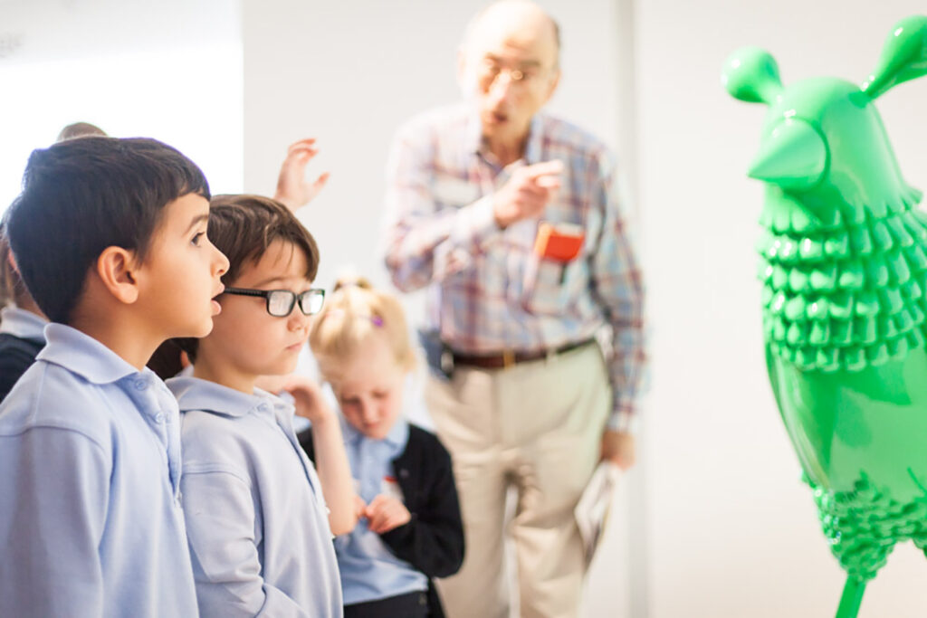 student tour green chicken Students look at a sculpture of a giant green chicken.