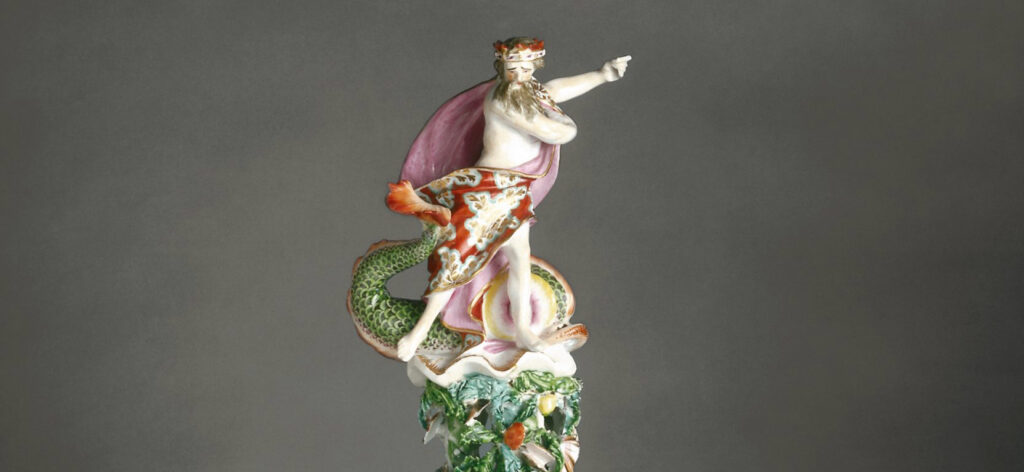 ceramic of a bearded man with a crown on his head holding one arm out to the side.